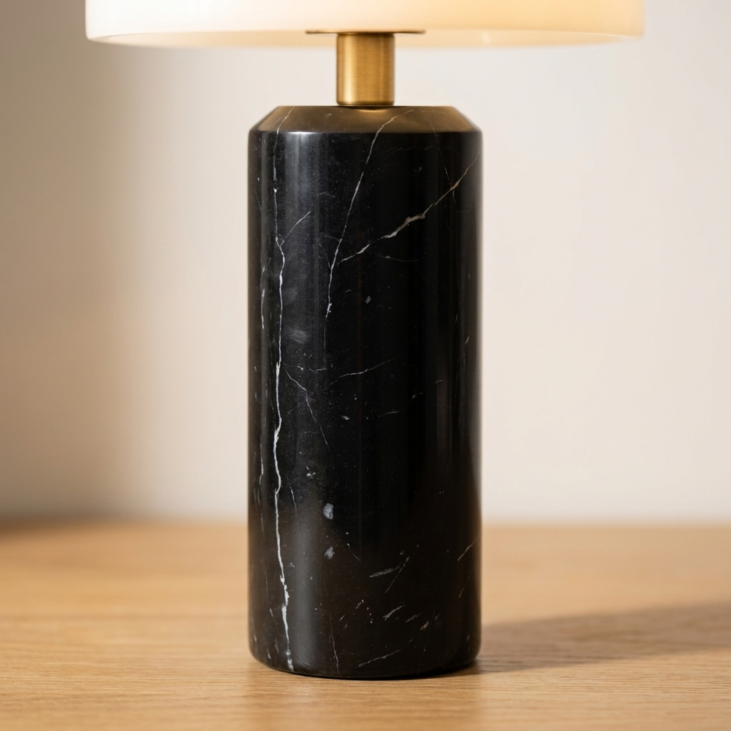 Gros plan sur les fines veines blanches de la base en marbre noir d'une lampe de chevet